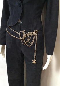 Chanel cursive chain belt worn at the waist. 